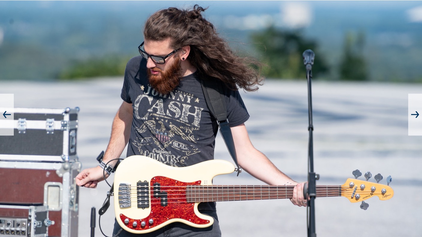 Philipp Zimmermann playing bass outdoors on stage